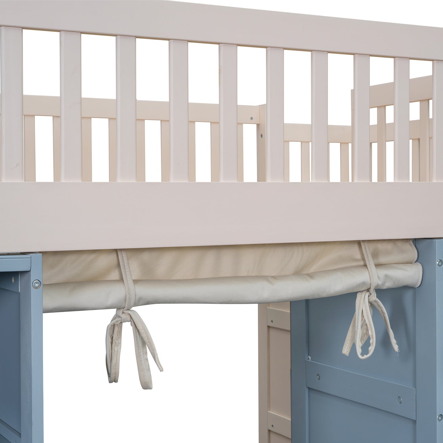 Closeup of beige crib mattress and white wooden safety rail detail