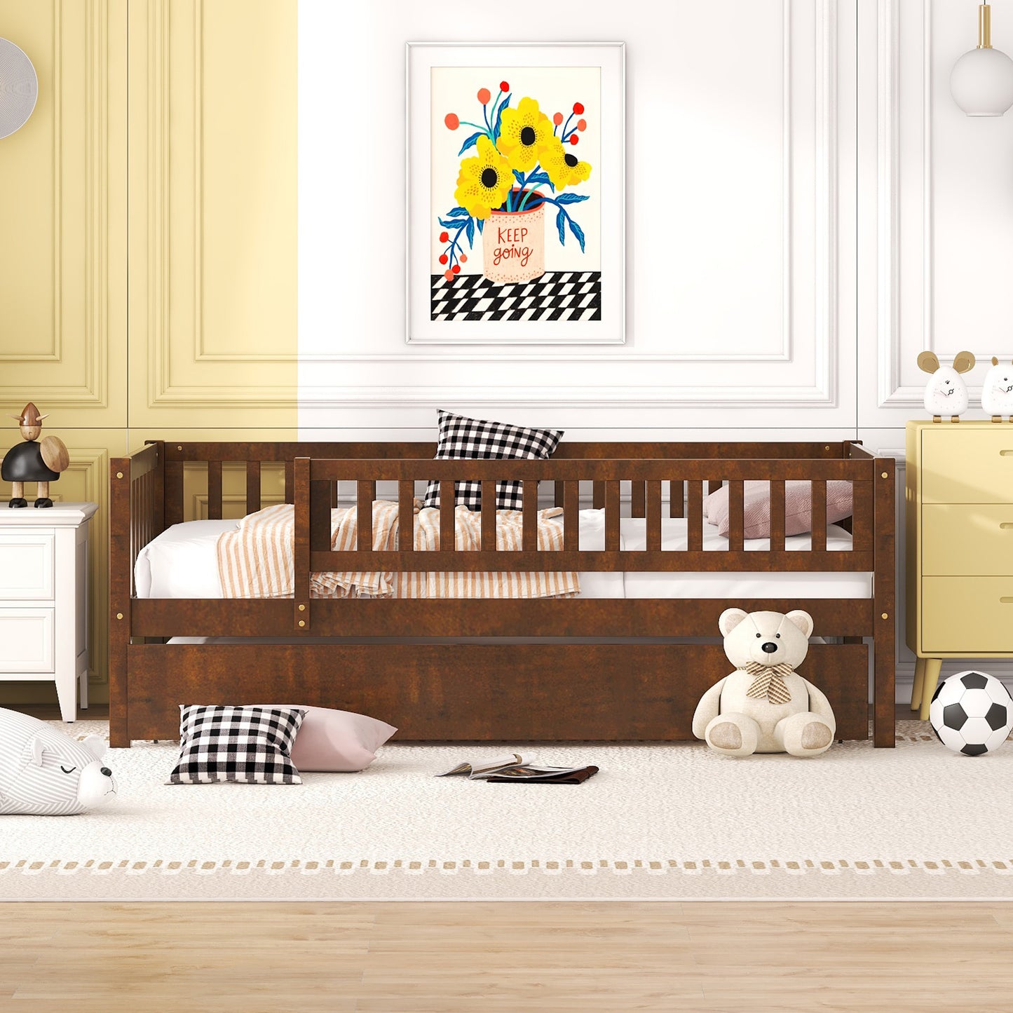 Dark wood toddler bed with pullout trundle and white bedding