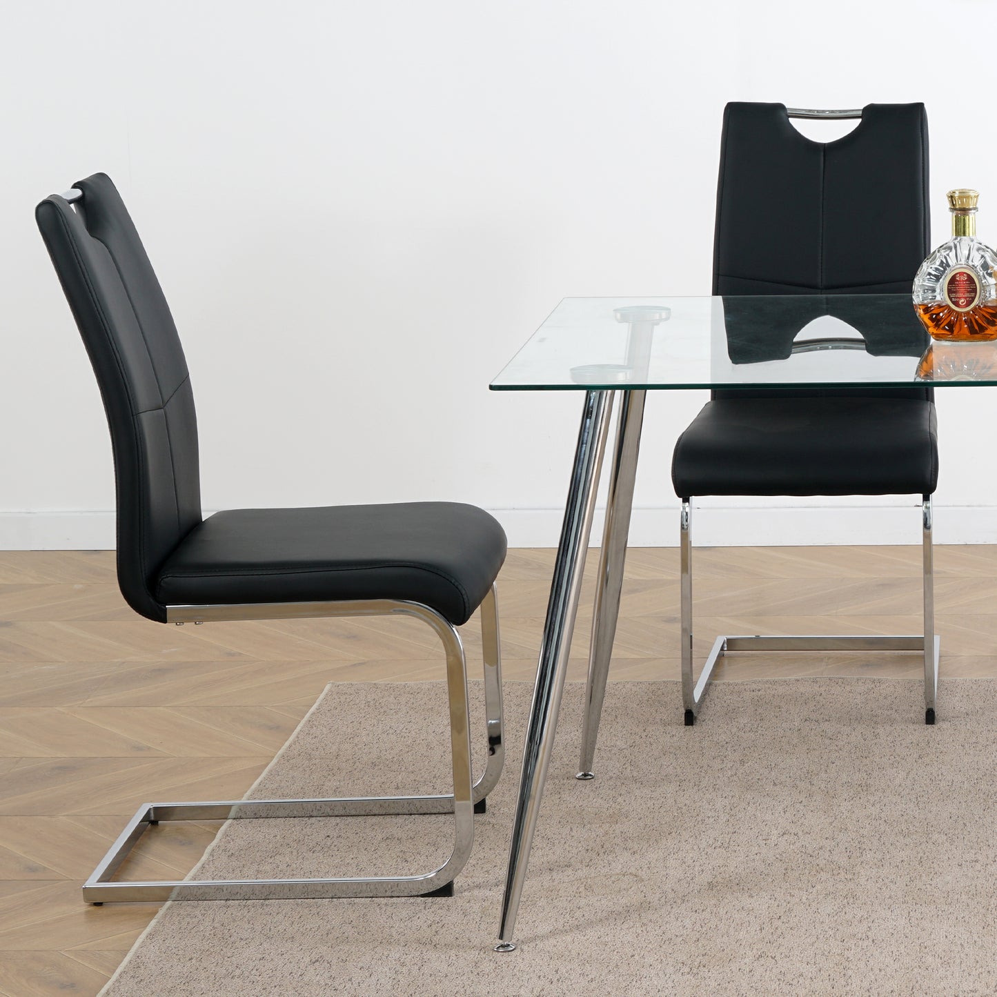 Black faux leather dining chair with chrome cantilever legs