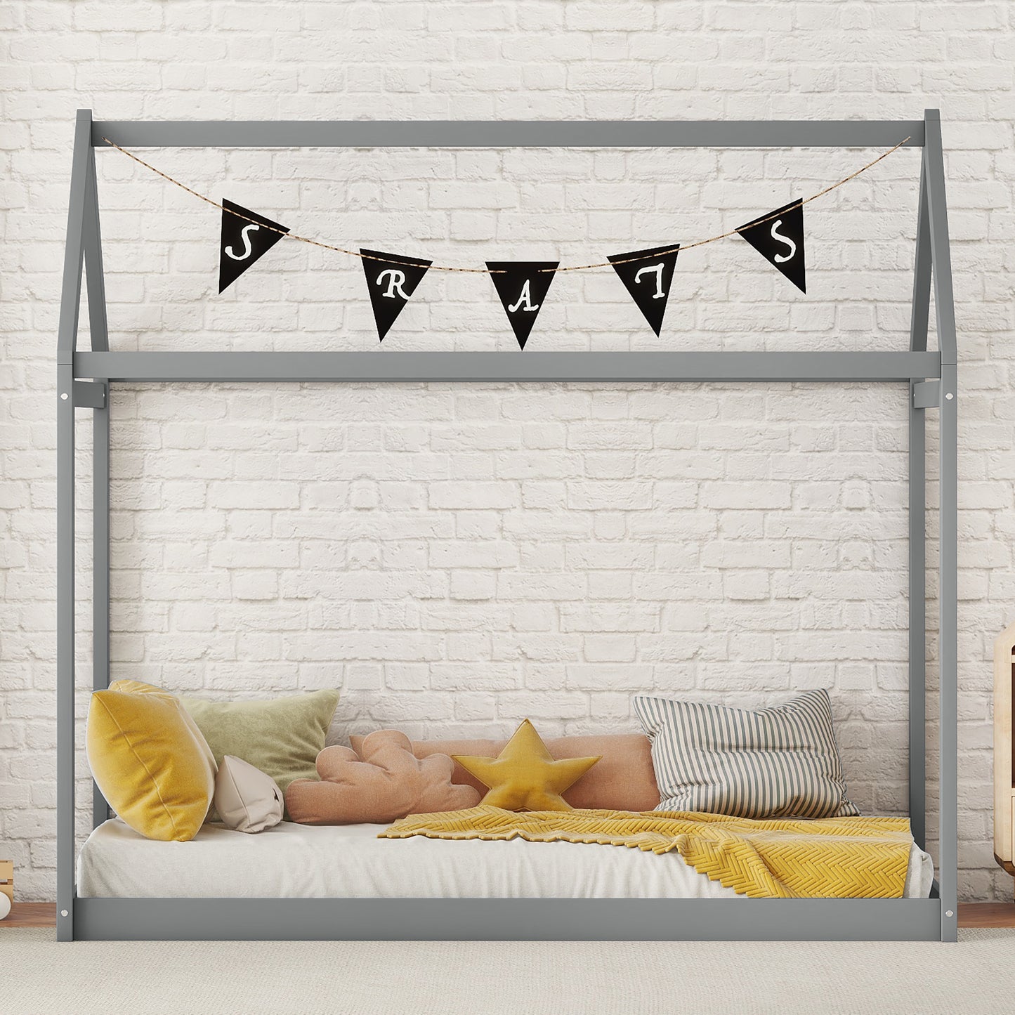Modern grey wooden house bed frame with a yellow star pillow and white brick backdrop