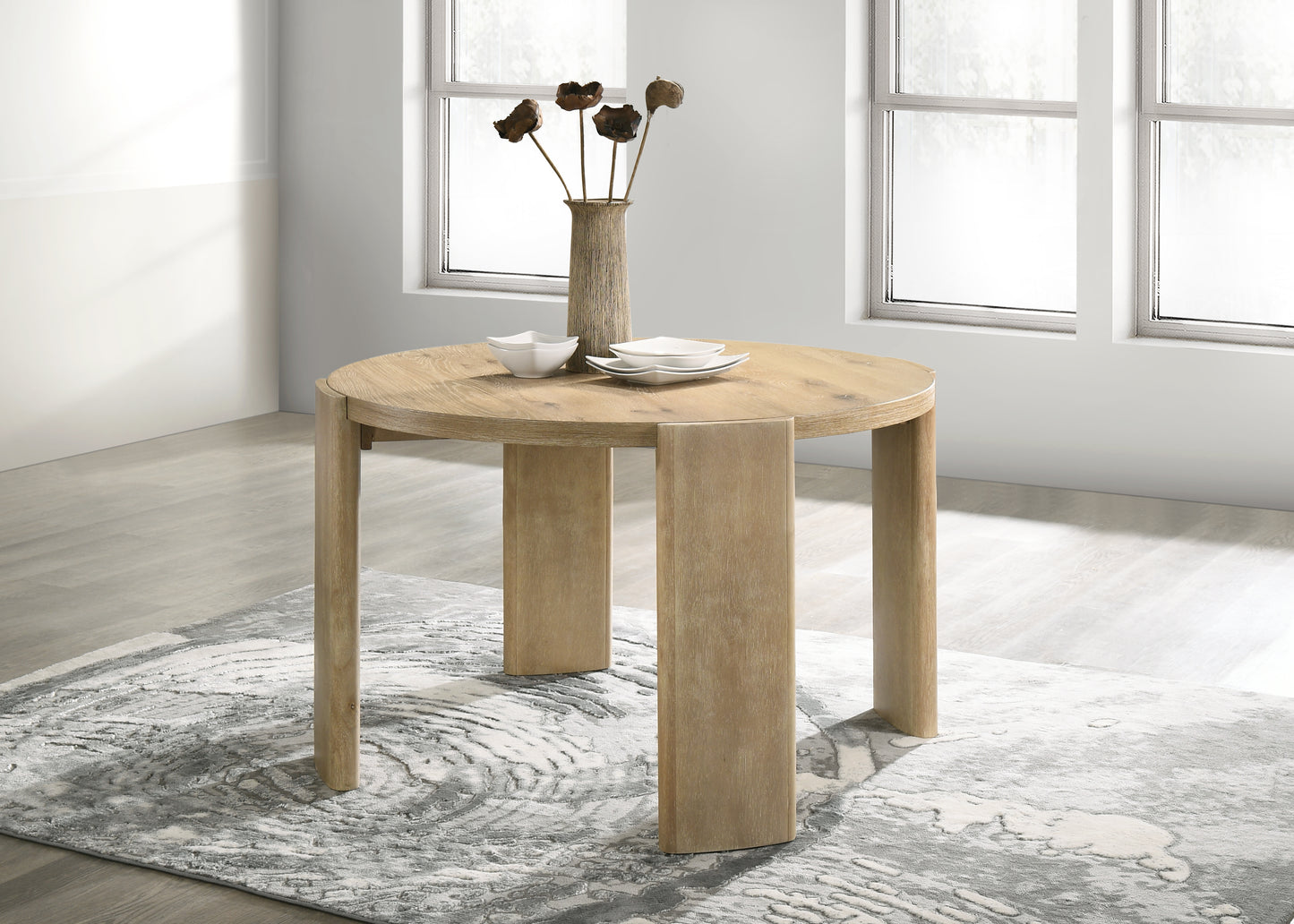 Round wood dining table with natural finish and minimalist design