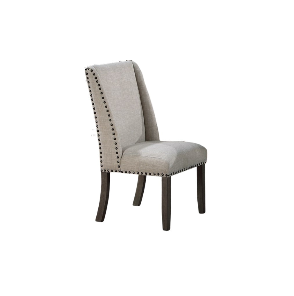 Light beige upholstered dining chair with nailhead trim and dark wood legs