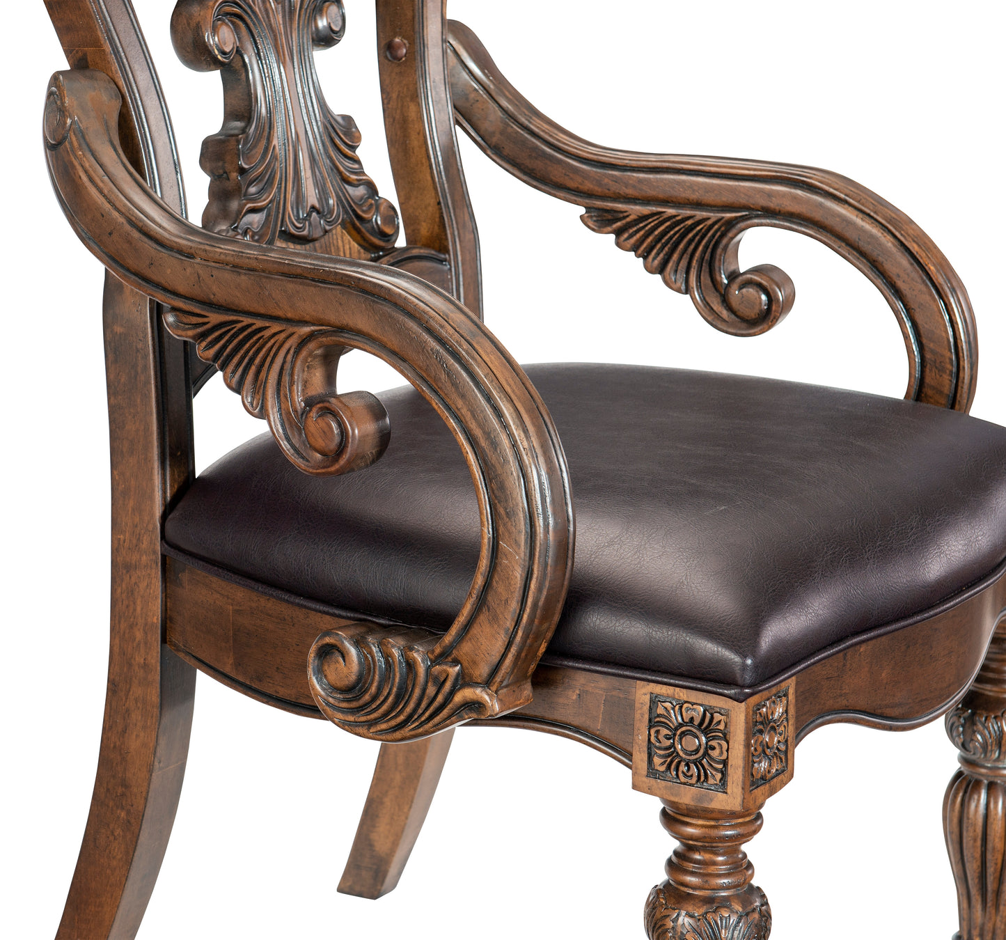 Ornate carved wooden armchair with dark brown faux leather seat