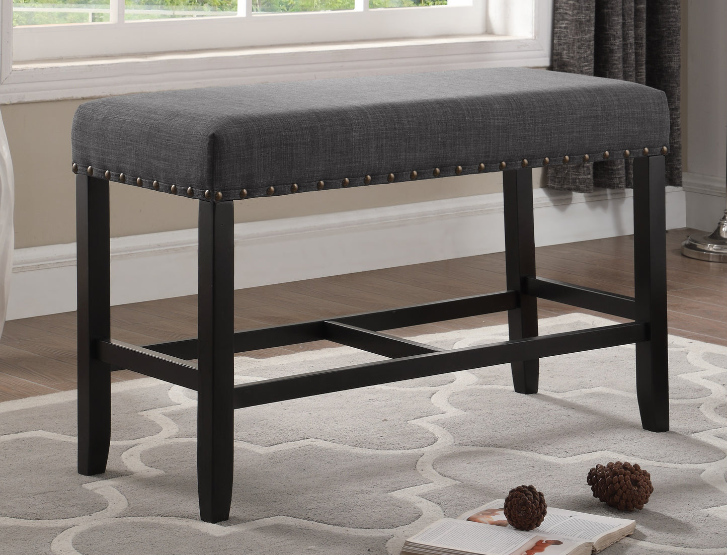 Dark grey upholstered counter stool with studded trim and dark wood legs