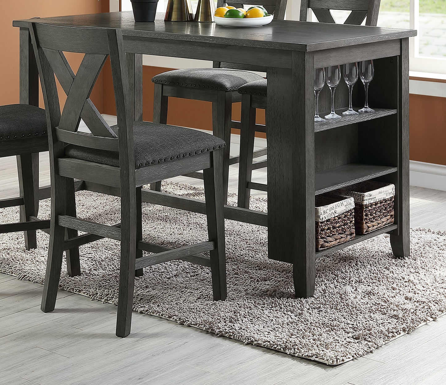 Grey wood counter height dining table with upholstered stools and builtin shelving
