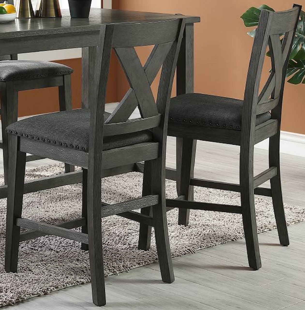 Dark grey wooden bar stool with upholstered seat and crisscross back design