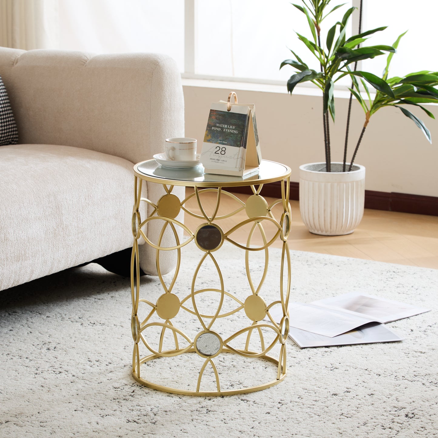 Gold metal accent table with glass top and geometric design