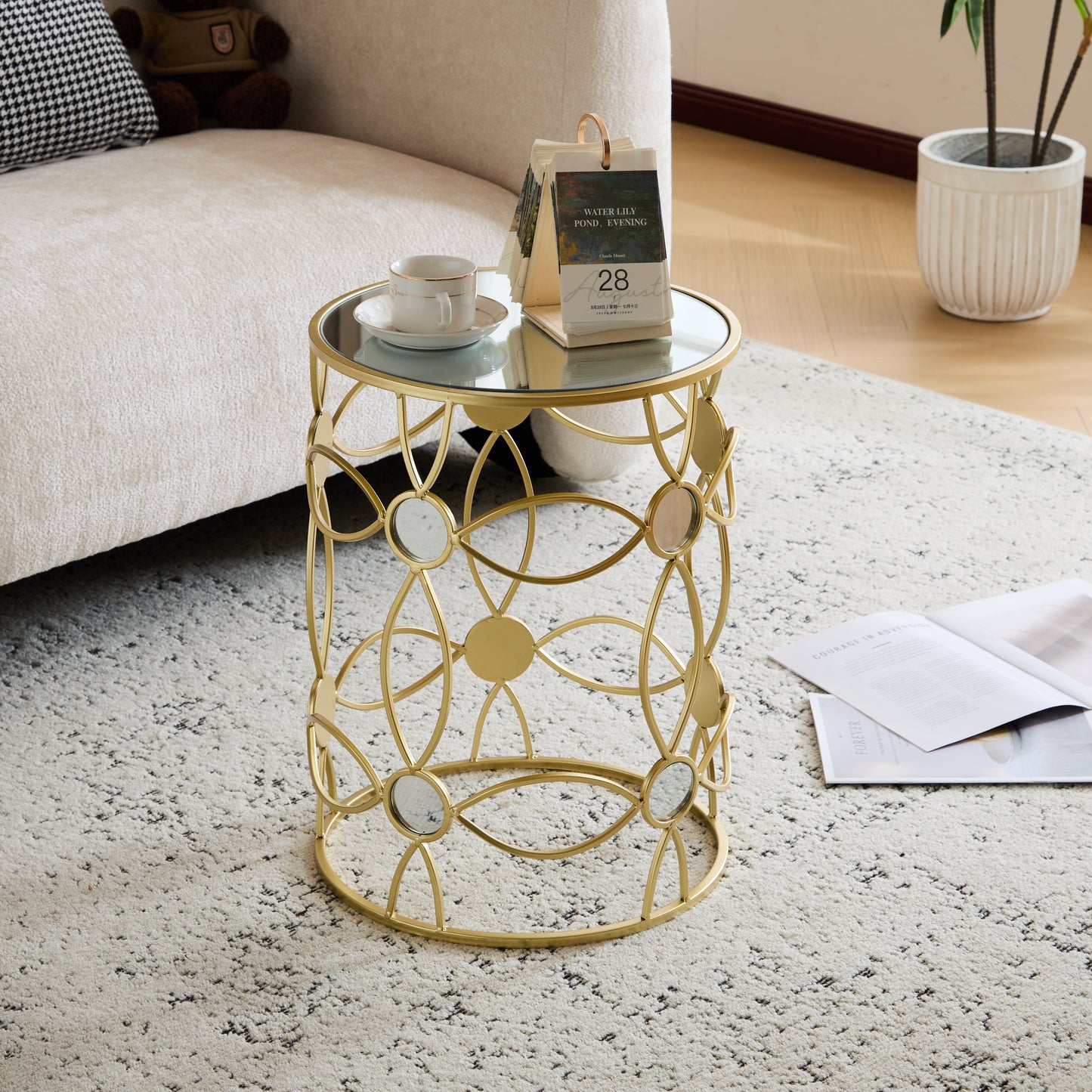 Gold metal side table with mirrored accents and glass top