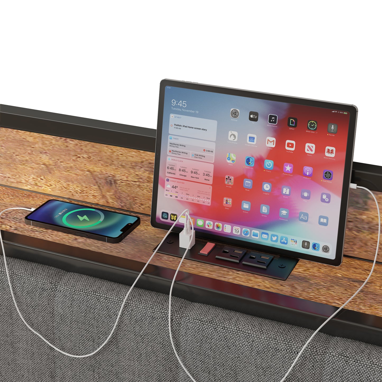 Silver iPad Pro on wooden desk with charging cables