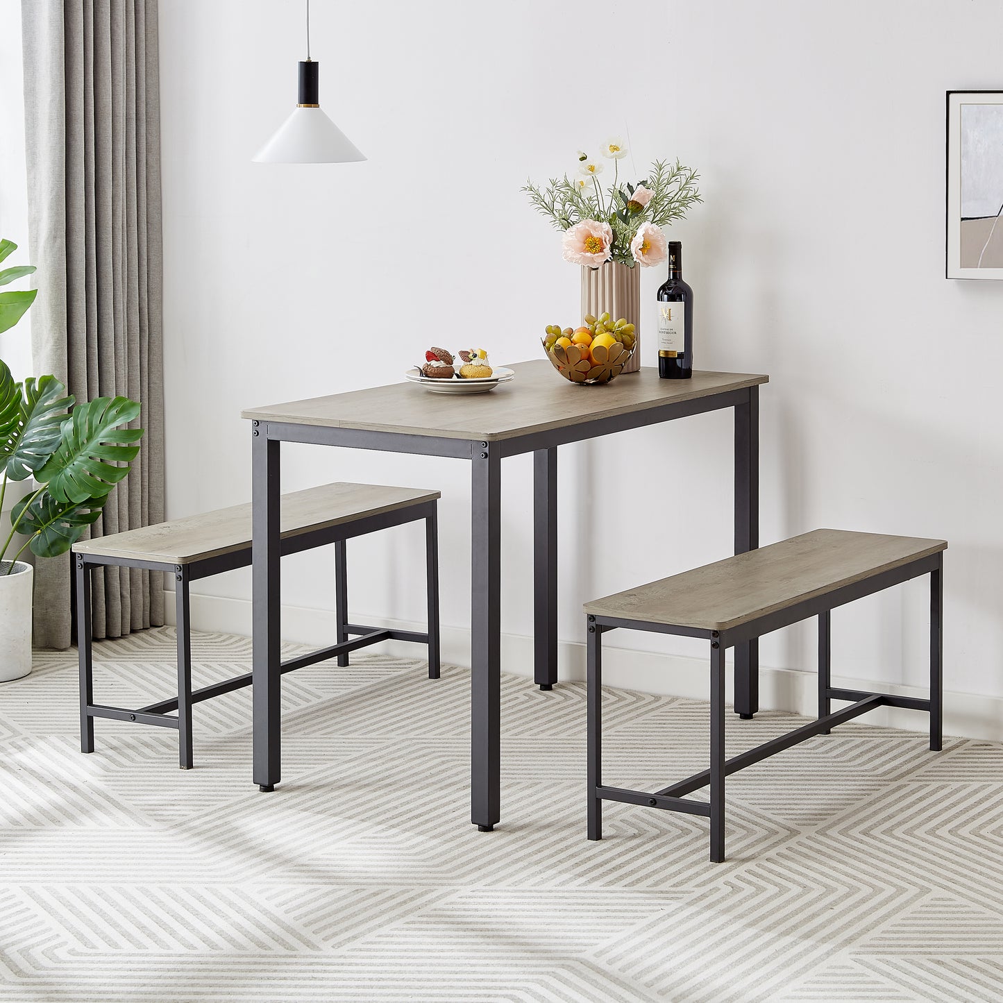 Gray wood grain dining table with black metal legs and two benches