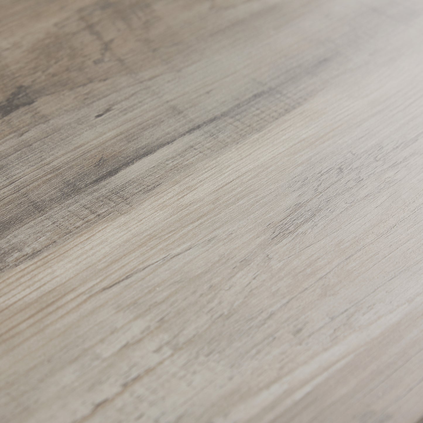 Light grey wood grain laminate flooring with subtle darker streaks