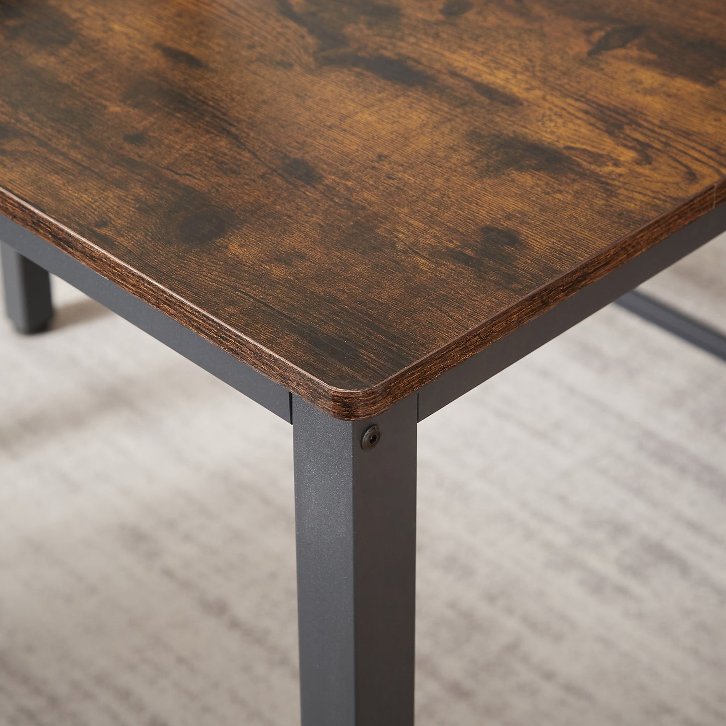 Rustic brown wood desk corner with industrial metal leg