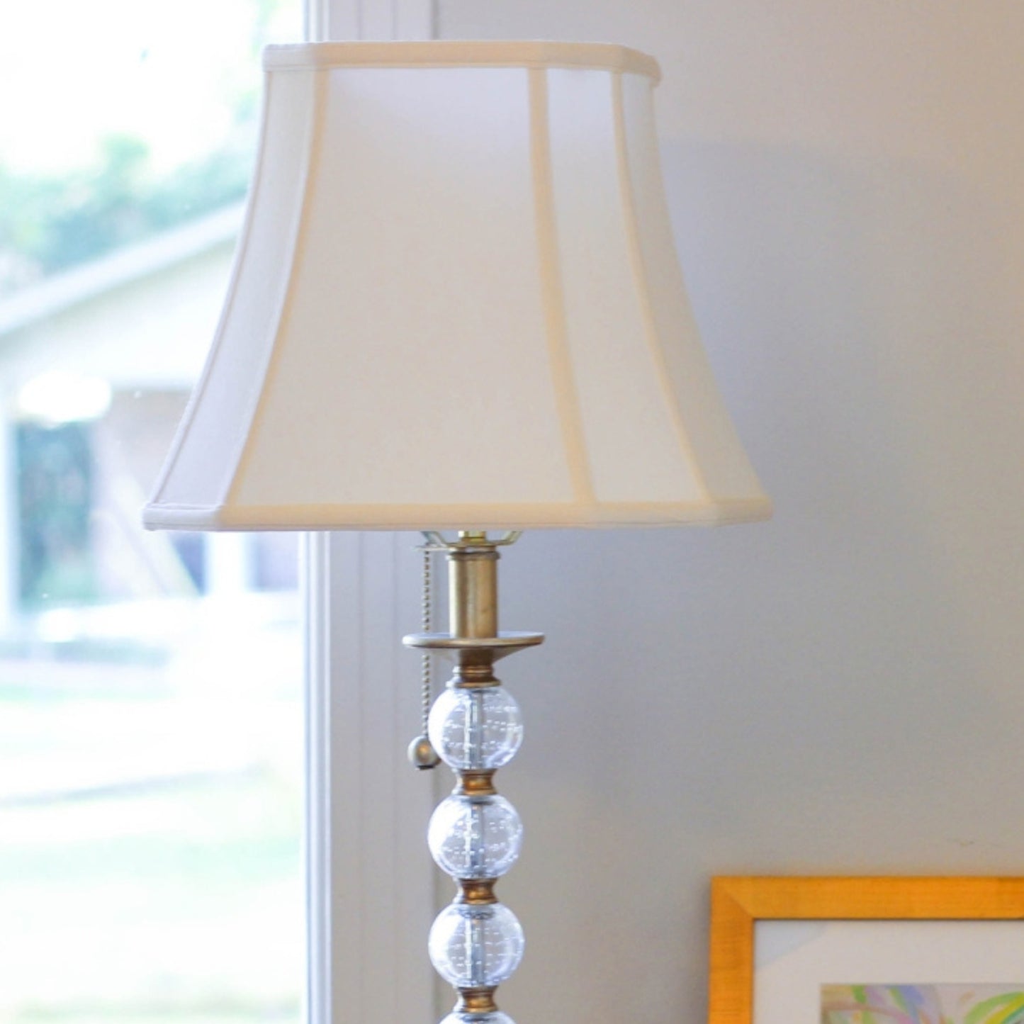 Cream fabric lampshade with brass accents and clear glass beads