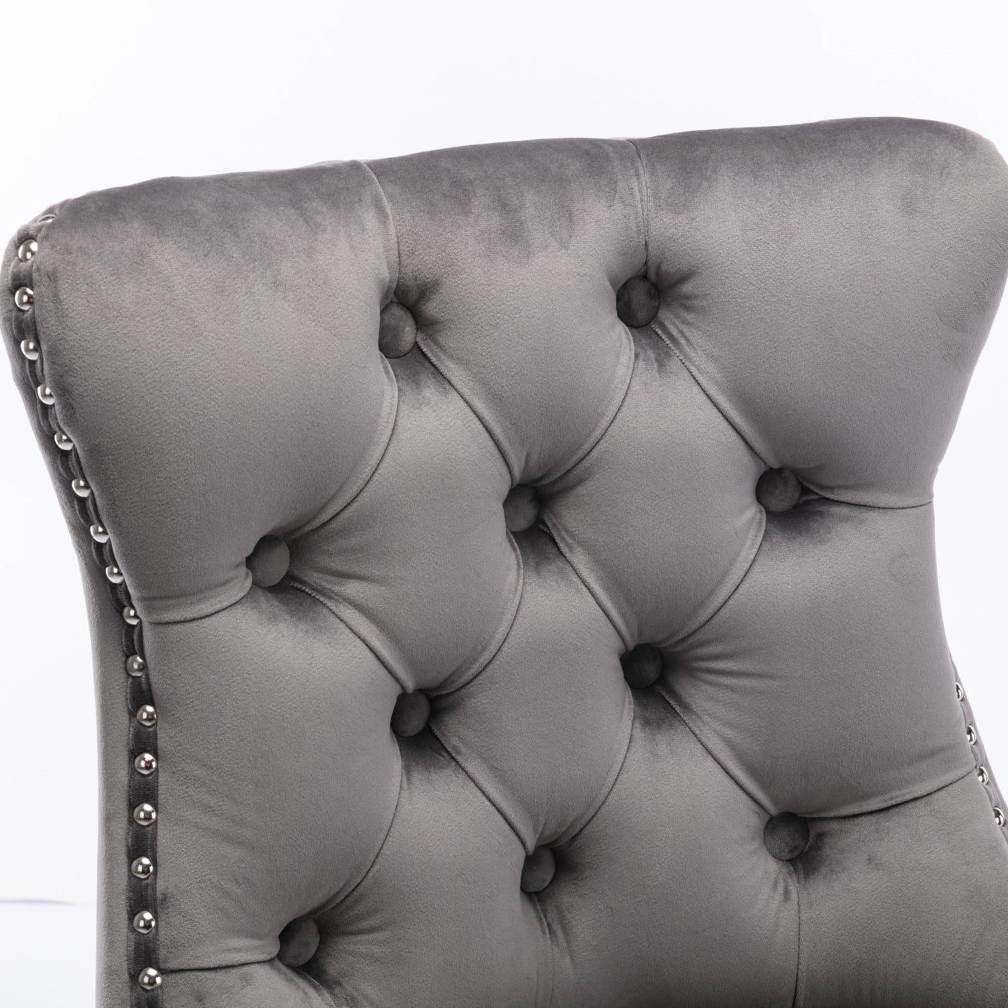 Grey velvet dining chair with tufted back and nailhead trim