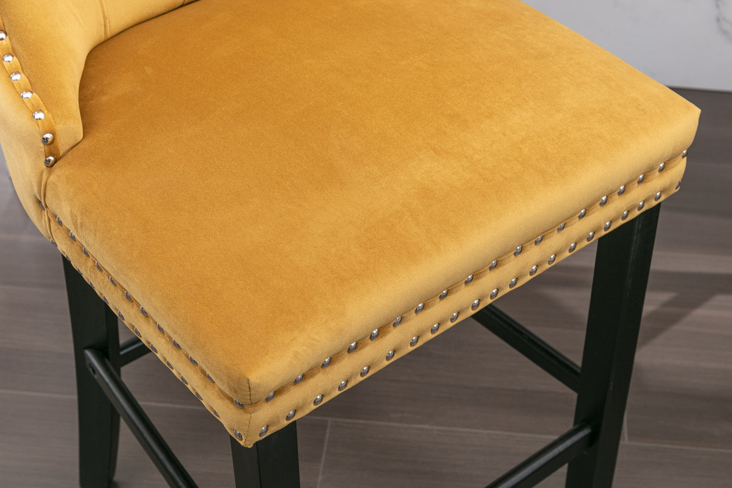 Yellow velvet bar stool with silver nailhead trim and black legs