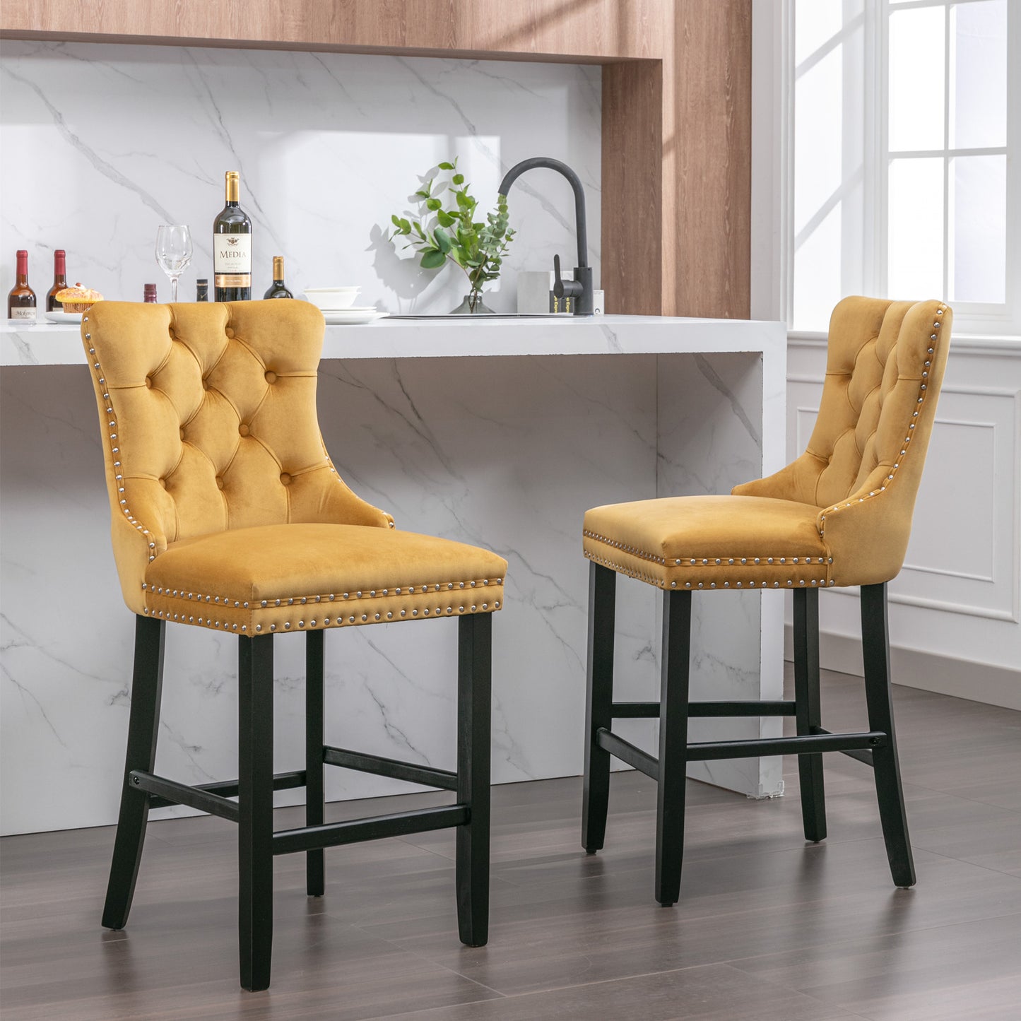 Tufted yellow velvet bar stool with silver nailhead trim and dark wood legs