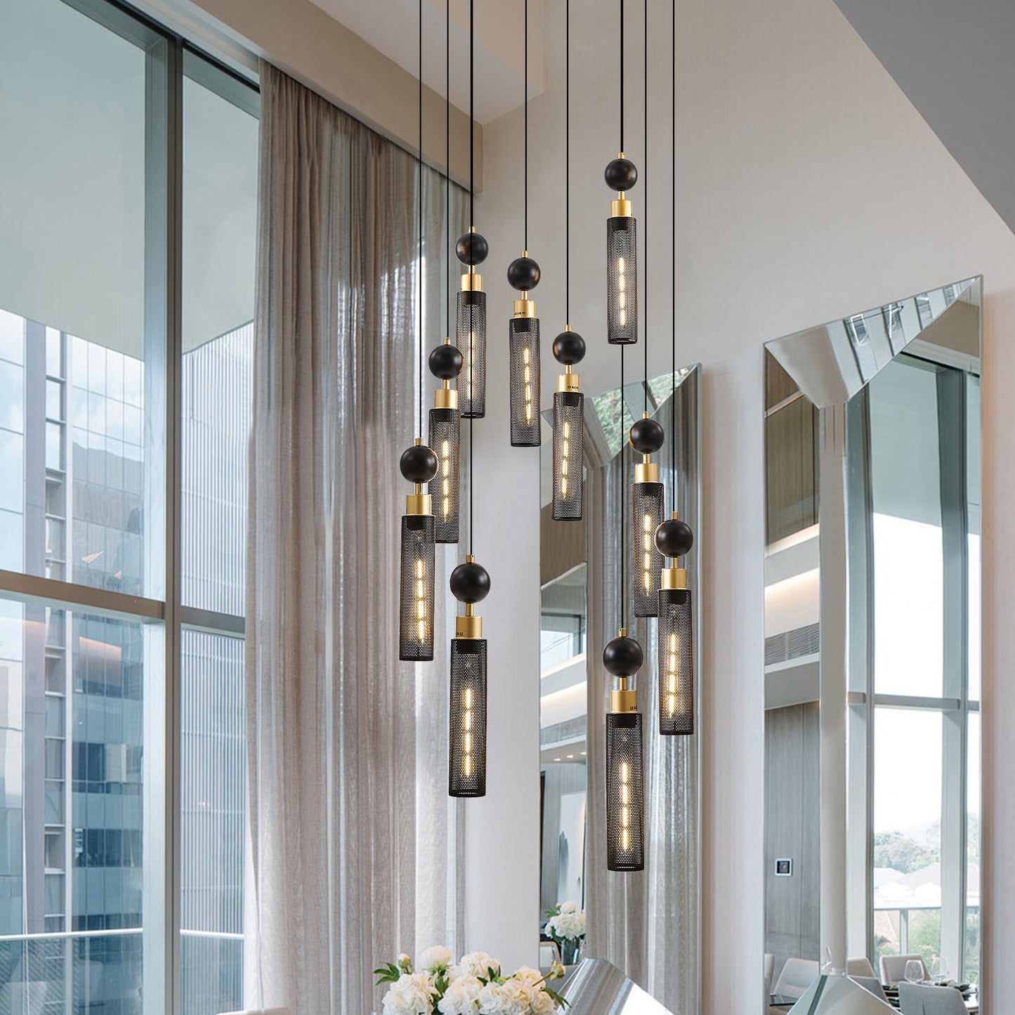 Modern black and gold pendant chandelier with mesh cylinder shades and orb accents