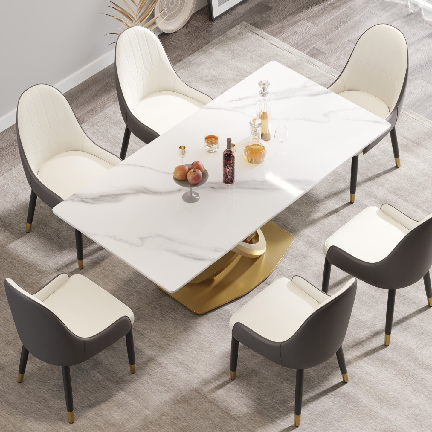 Modern marble dining table with gold pedestal base and cream chairs