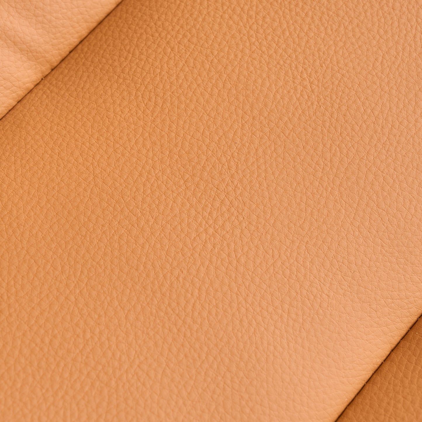 Closeup of textured tan genuine leather upholstery