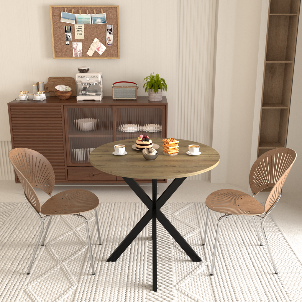 Round wood dining table with black cross base and two chairs