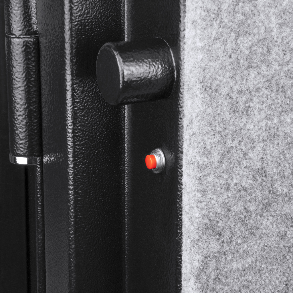 Black metal safe door with textured finish and red button