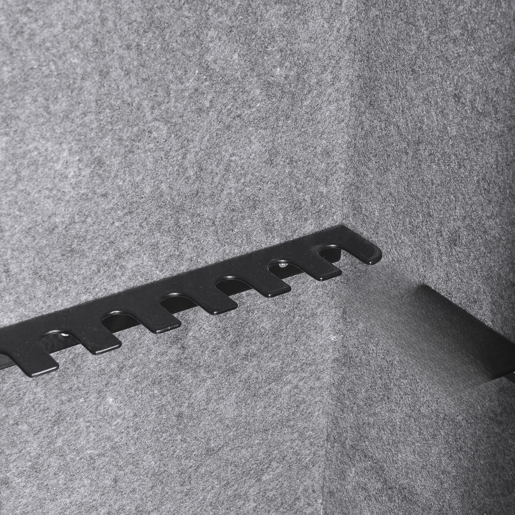 Black metal gun rack on gray felt background