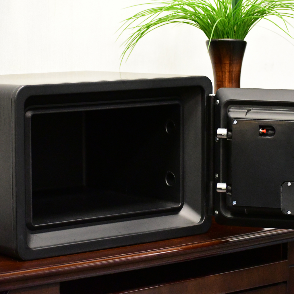 Open black home safe with grey interior and visible latch mechanism