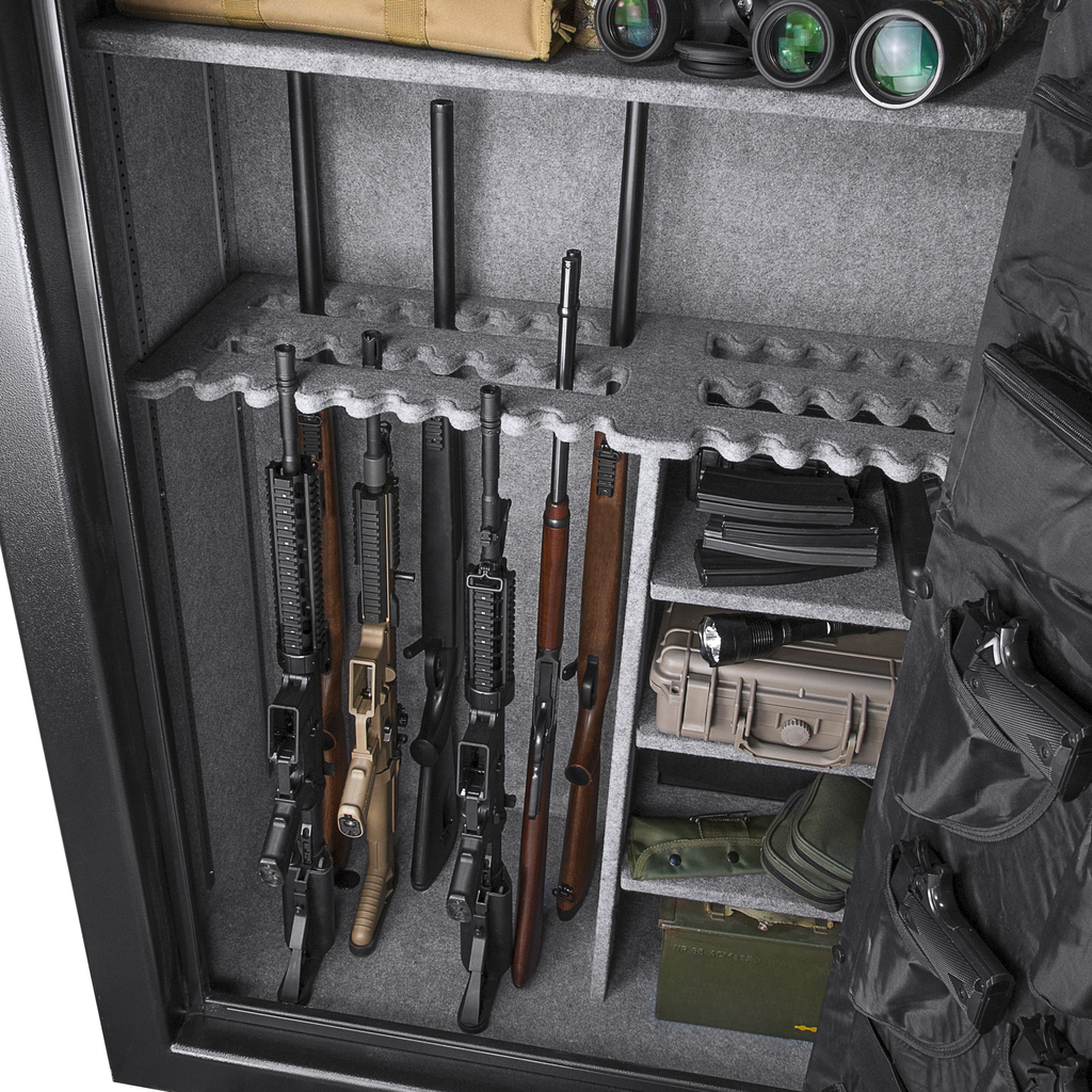 Four rifles and one shotgun in a gray interior gun safe