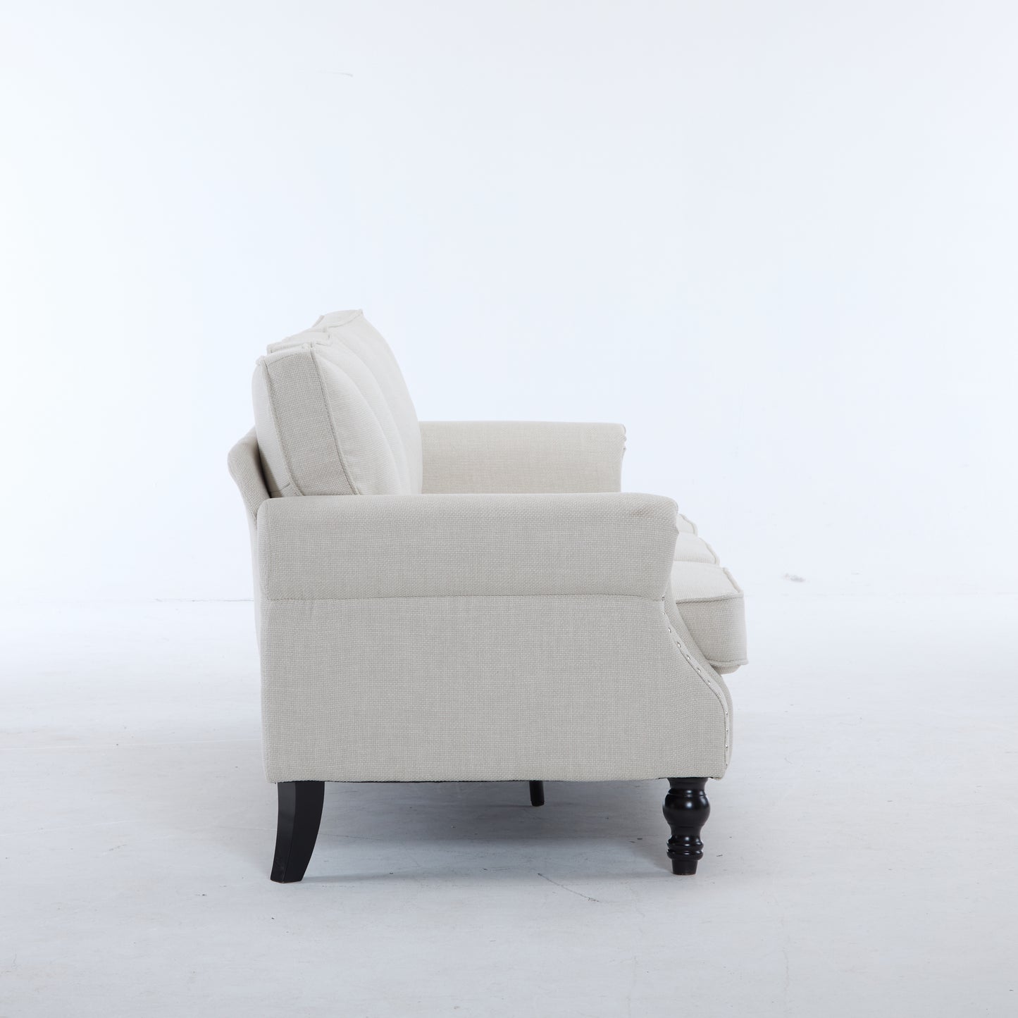 Elegant beige upholstered sofa with button tufting and dark wooden legs