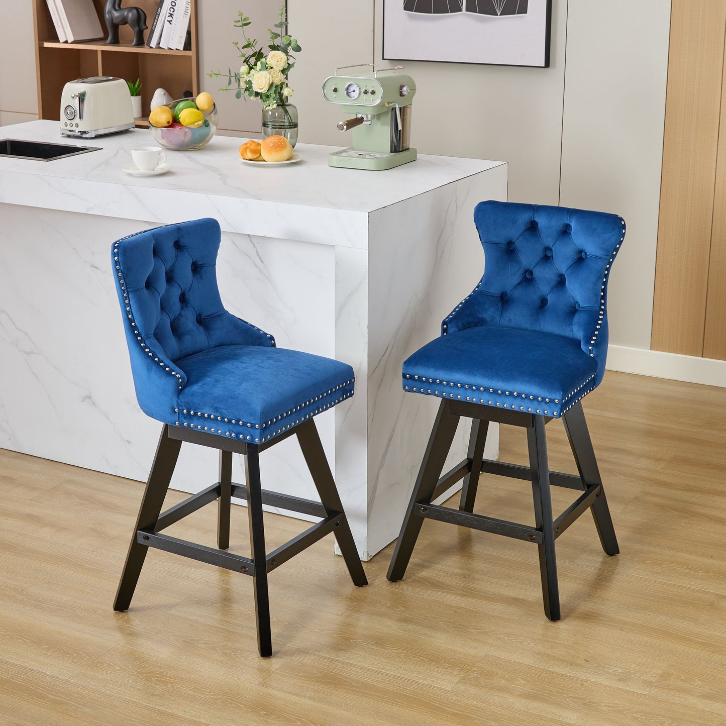 Tufted royal blue velvet bar stool with silver nailhead trim and black wooden legs