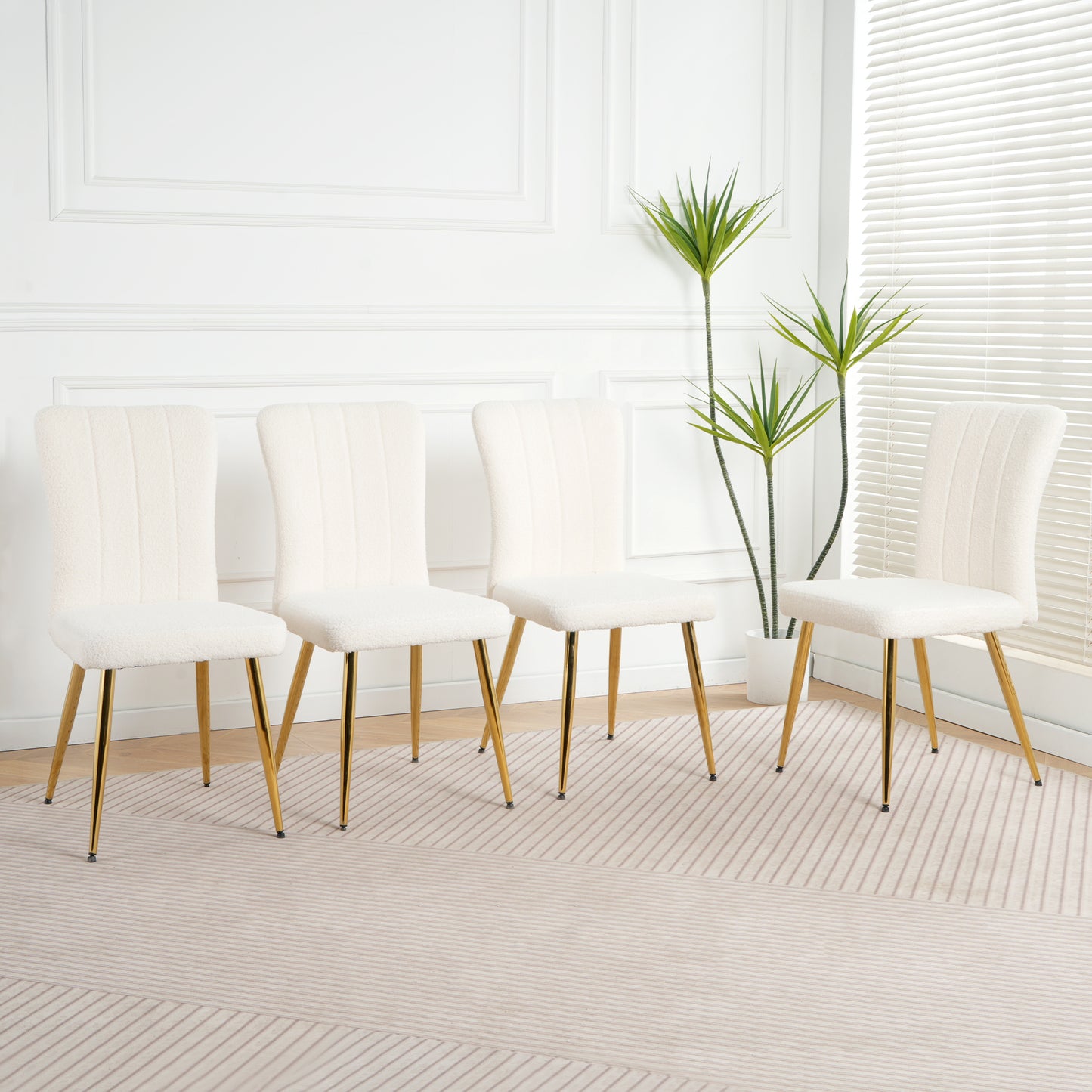 Four offwhite sherpa dining chairs with gold metal legs