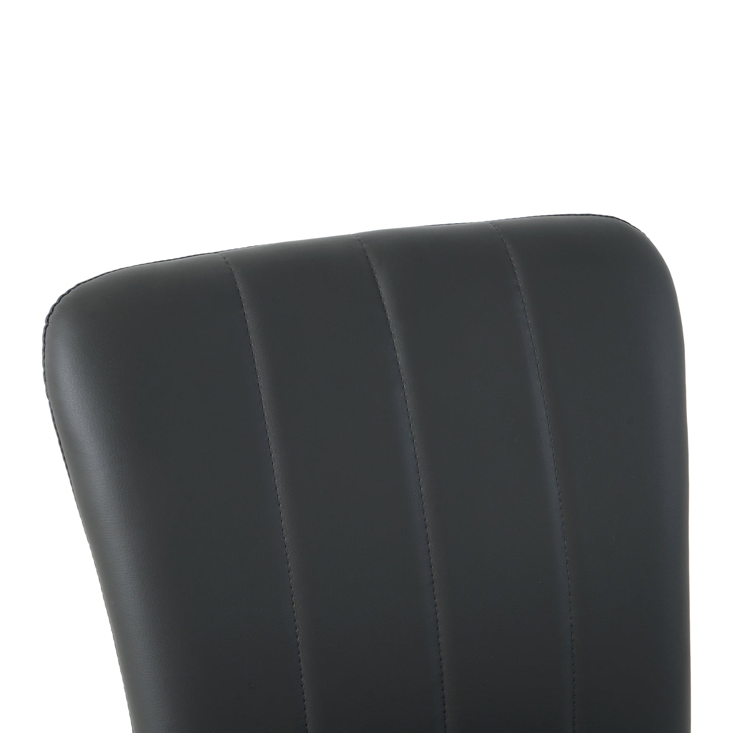 Closeup of black faux leather chair back with vertical channel tufting