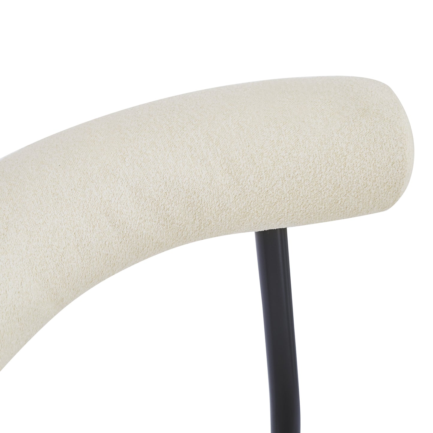 Cream textured upholstery on curved chair back with black metal leg