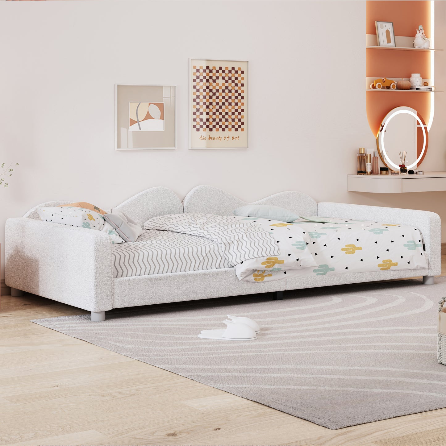White upholstered daybed with waveshaped headboard and playful cactus print bedding