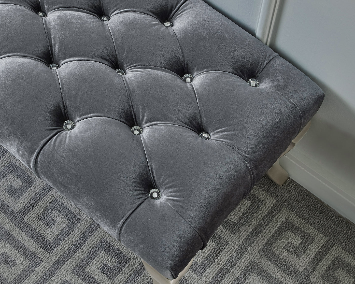 Tufted grey velvet ottoman with crystal accents
