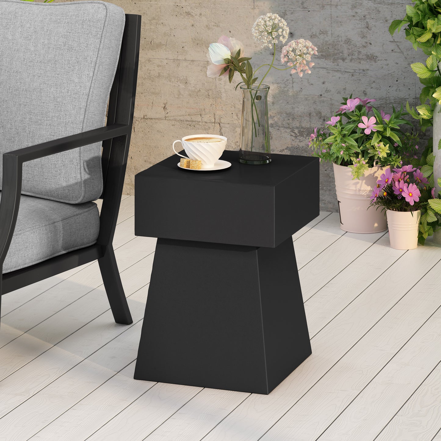 Modern black geometric end table with coffee cup