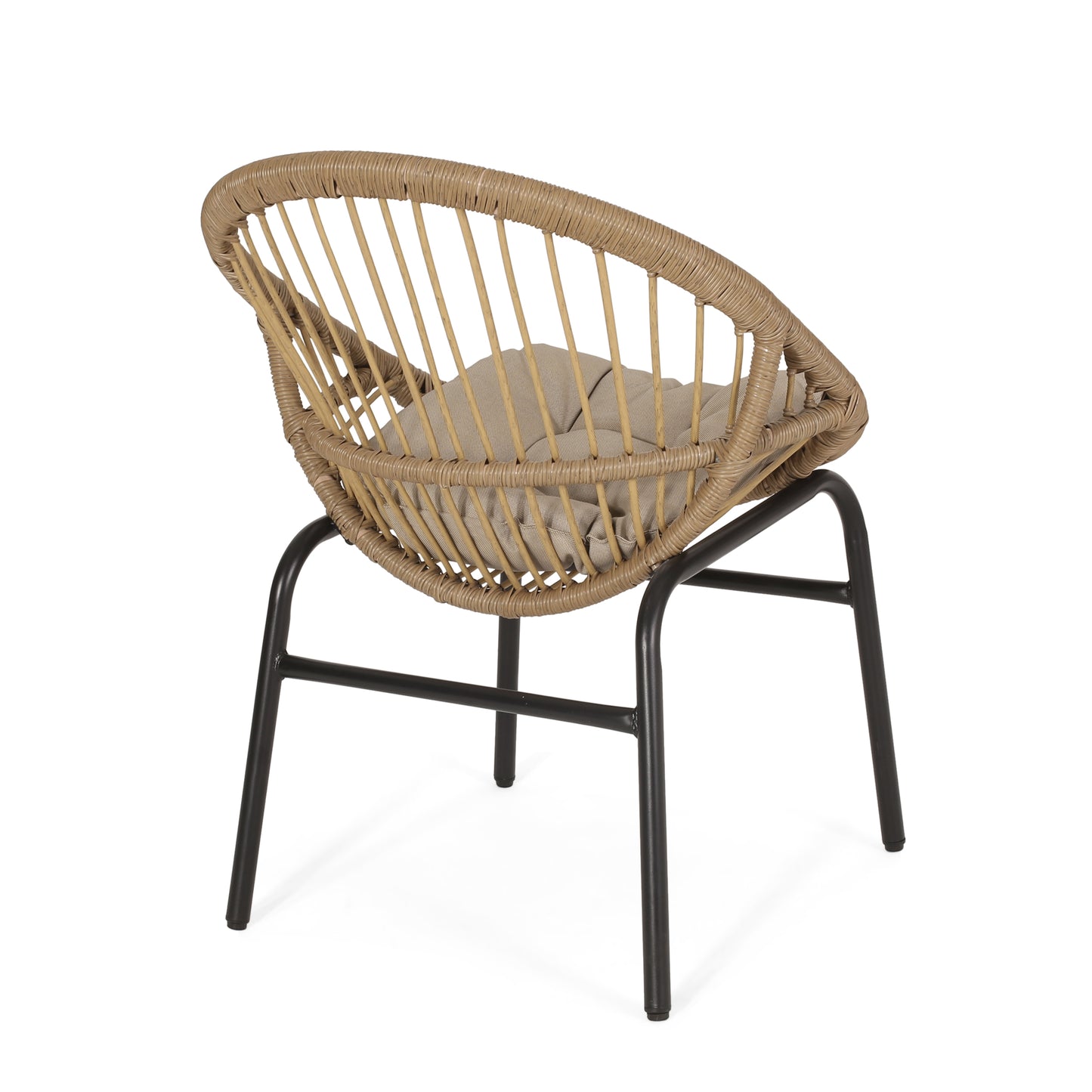 Tan rattan accent chair with black metal legs and neutral cushion