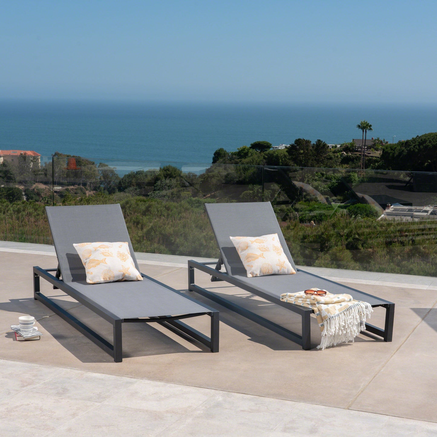 Grey fabric patio chaise lounge with black metal frame