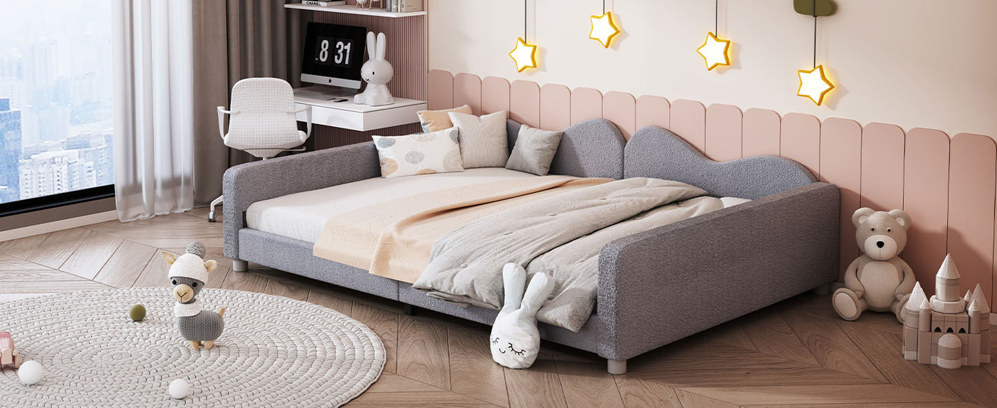 Grey fabric sofa bed with childrens bedding and plush toys