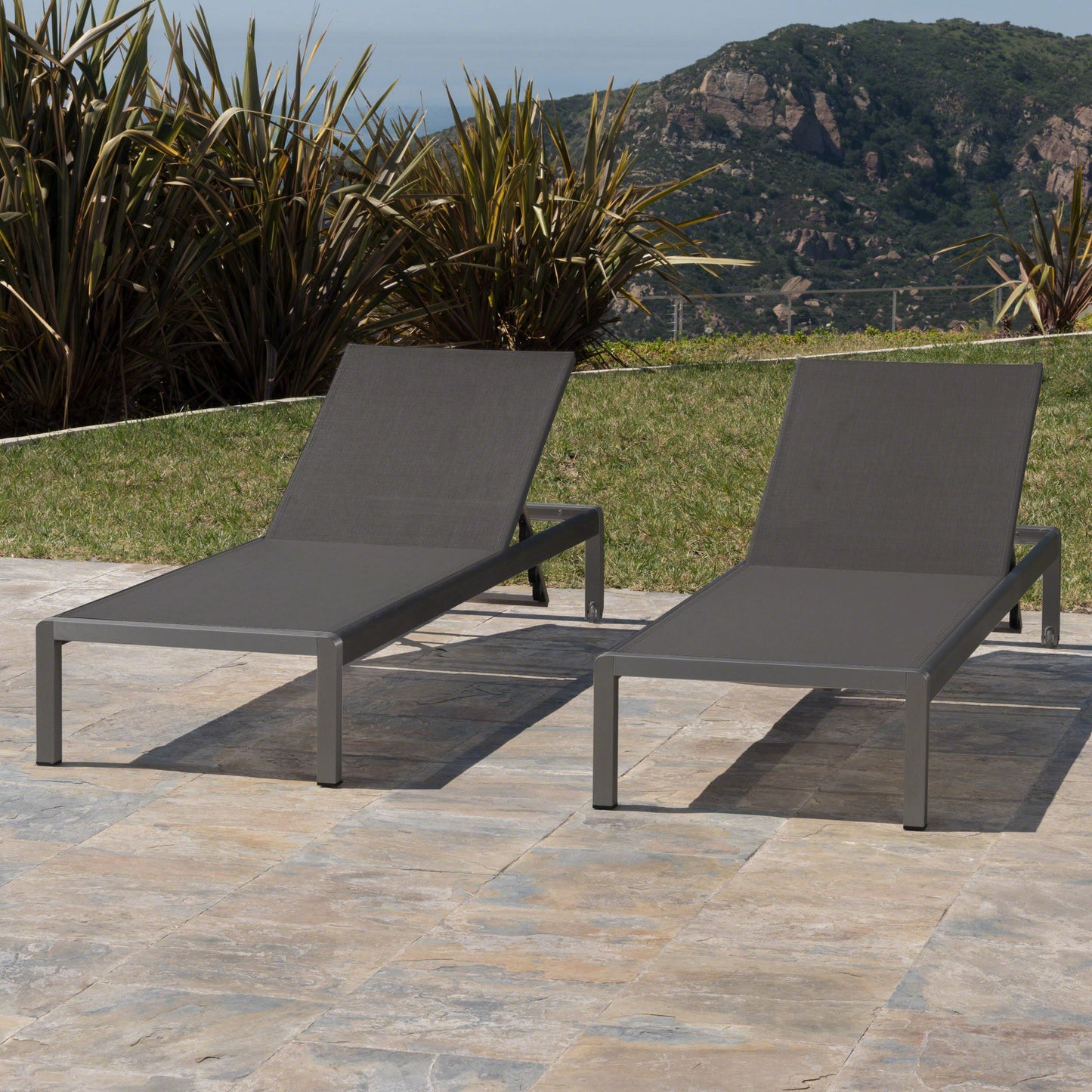 Modern grey aluminum outdoor lounge chair with dark grey fabric sling