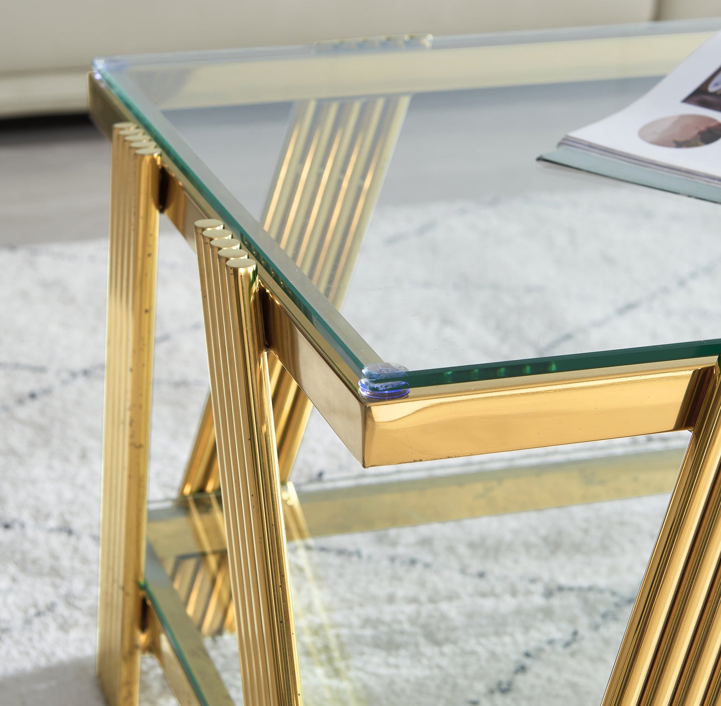 Gold metal ribbed leg detail on modern glass coffee table
