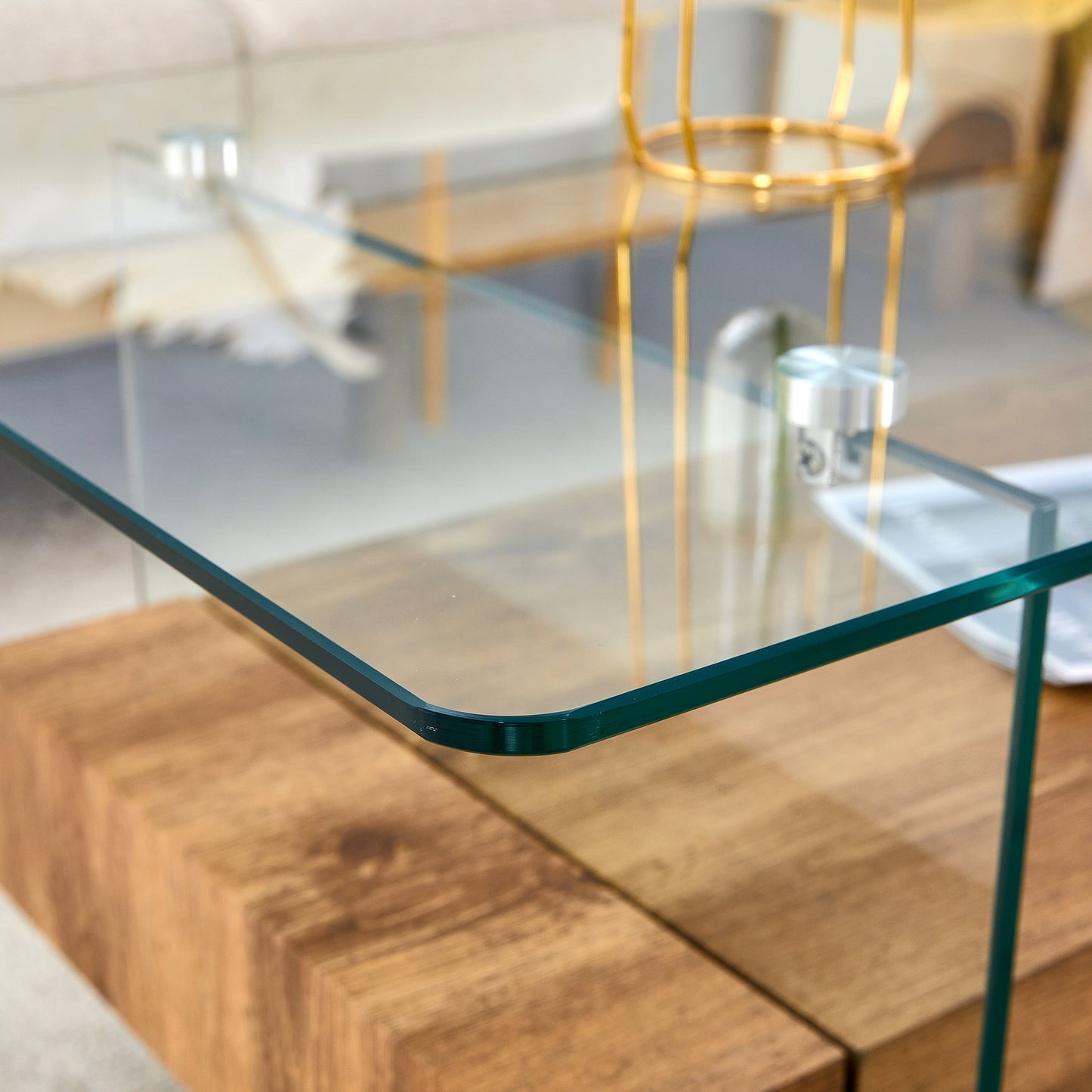 Modern clear glass coffee table with a natural wood base