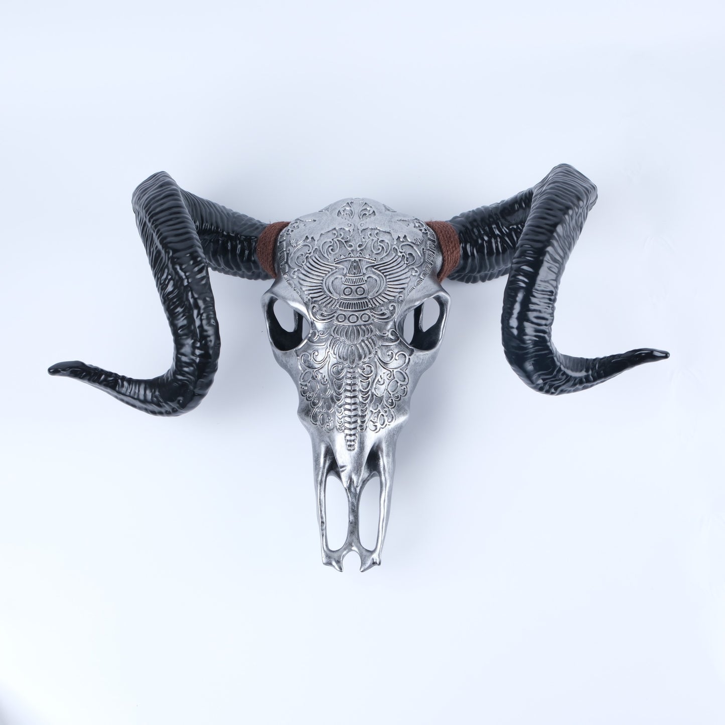 Ornate silver bull skull wall decor with large black horns