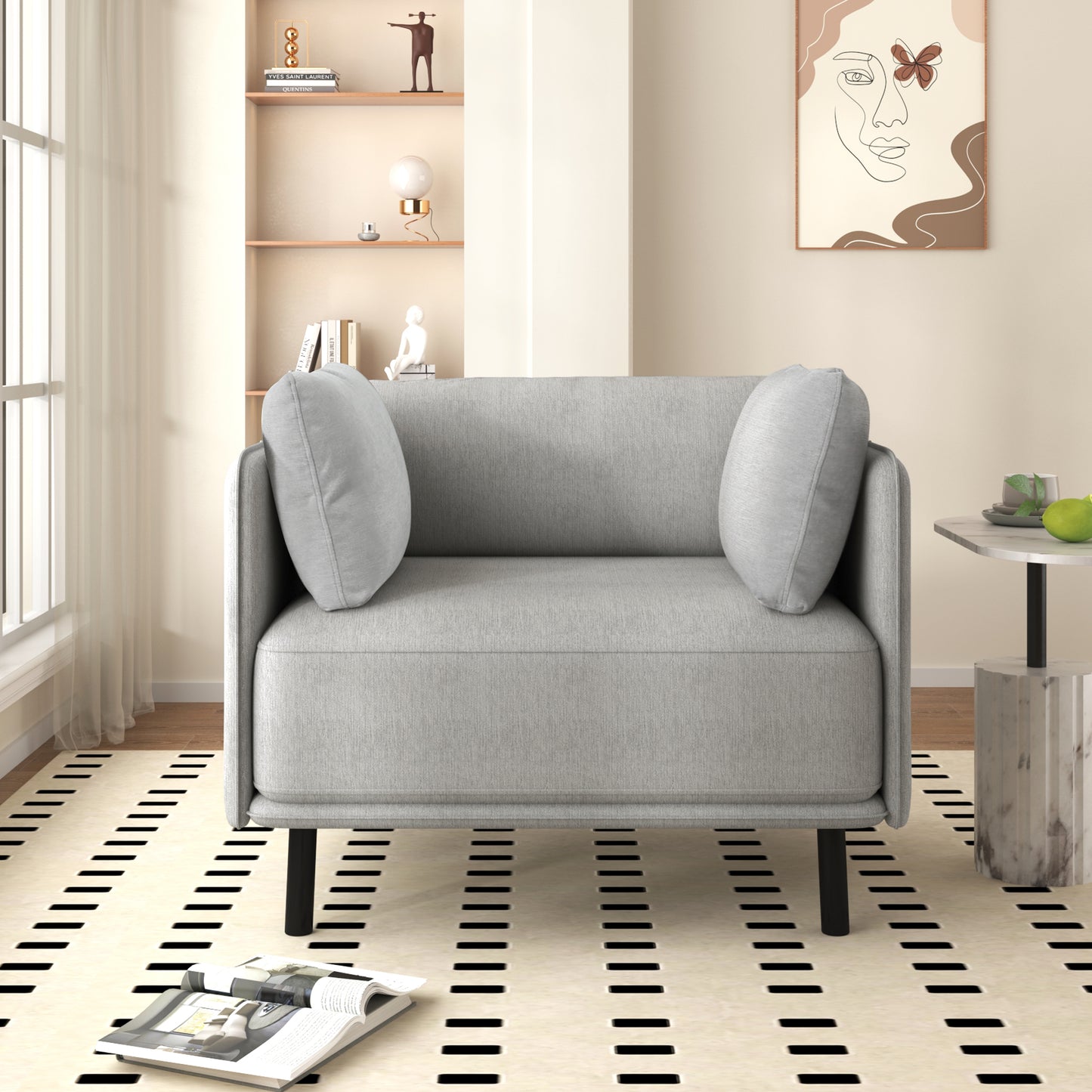 Light gray fabric armchair with plush cushions and black legs