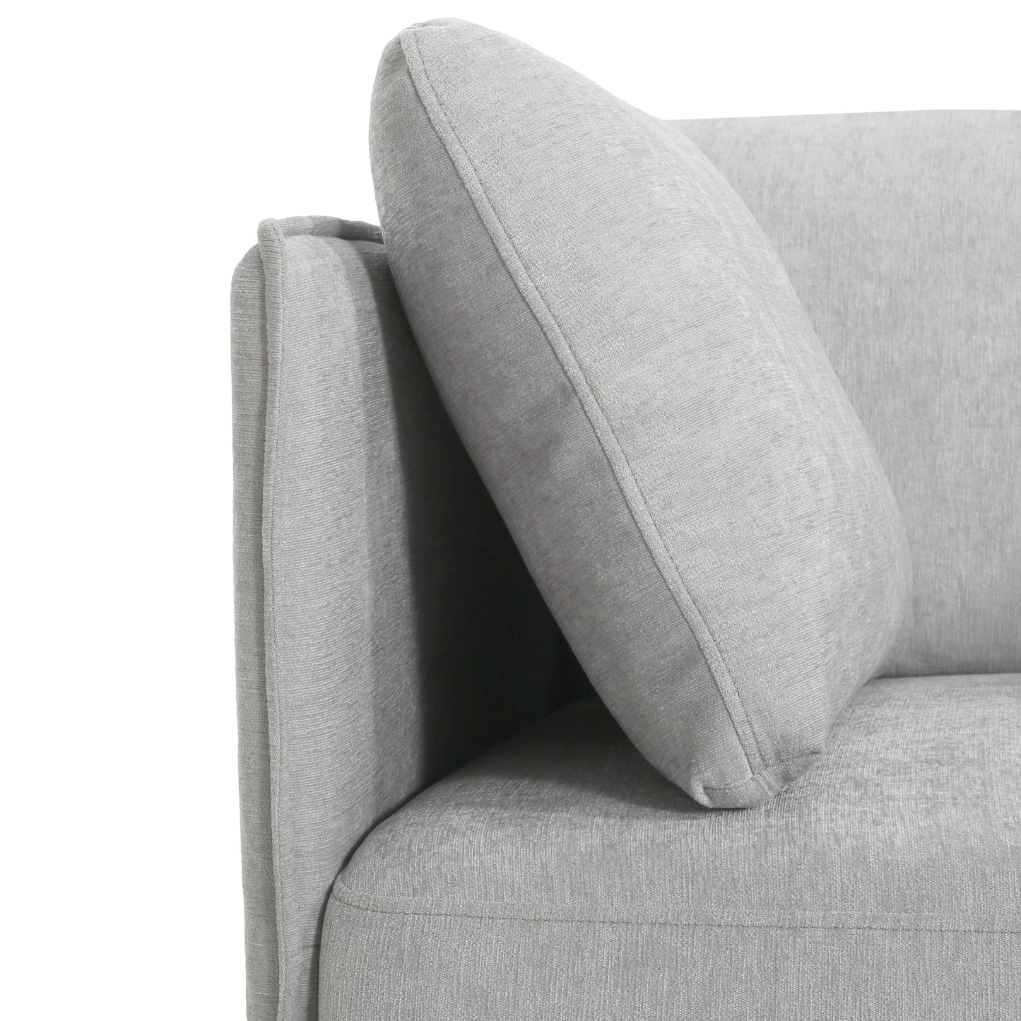 Closeup of a plush grey sofa arm with textured fabric and a matching throw pillow