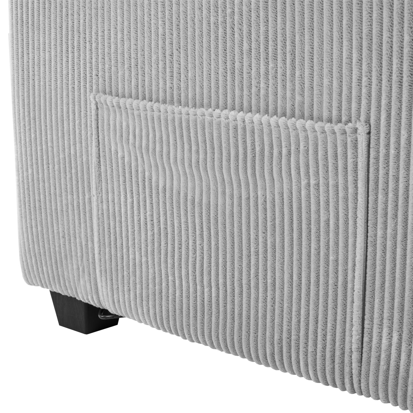 Closeup of a grey corduroy sofa with a side pocket detail