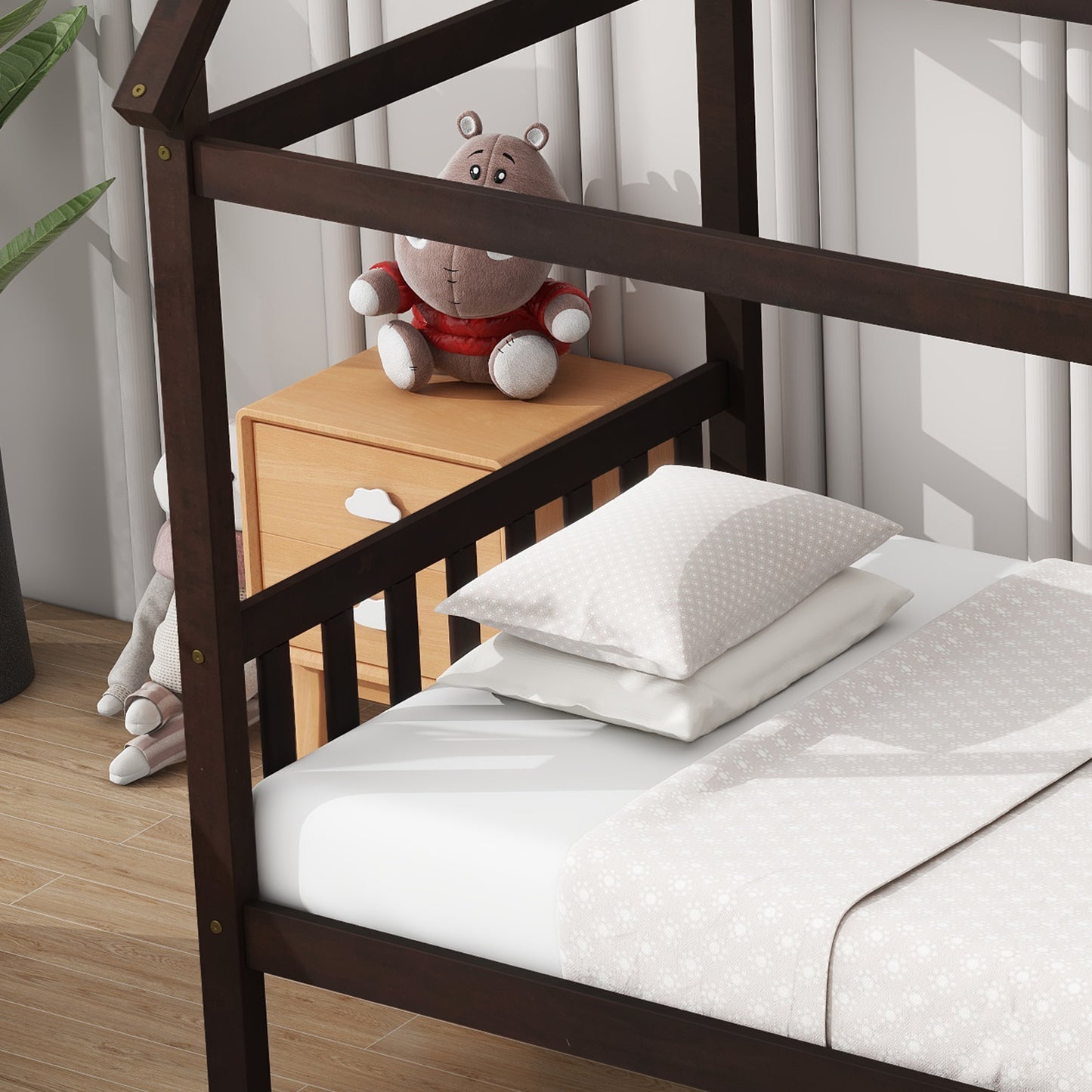 Dark wood house bed frame with playful pillows and stuffed animal