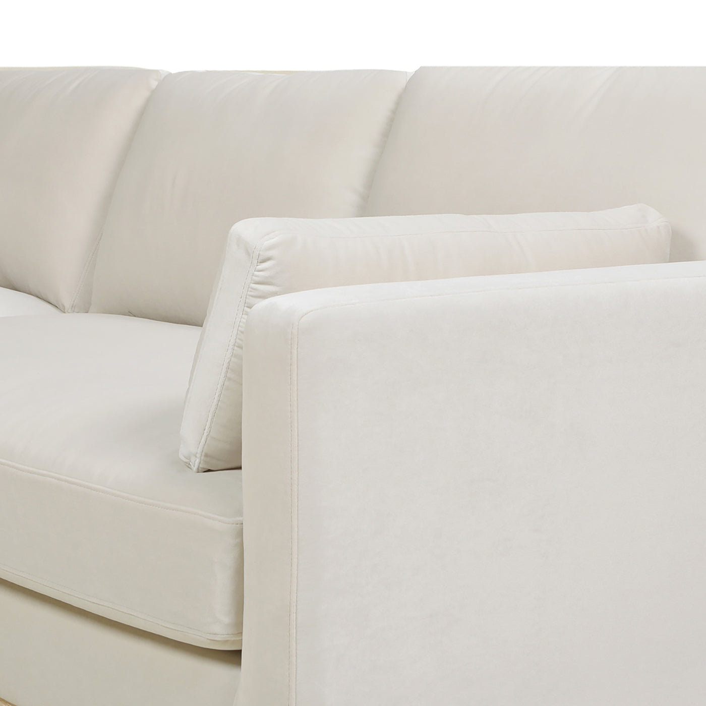 Plush cream sofa armrest detail with stitched seams
