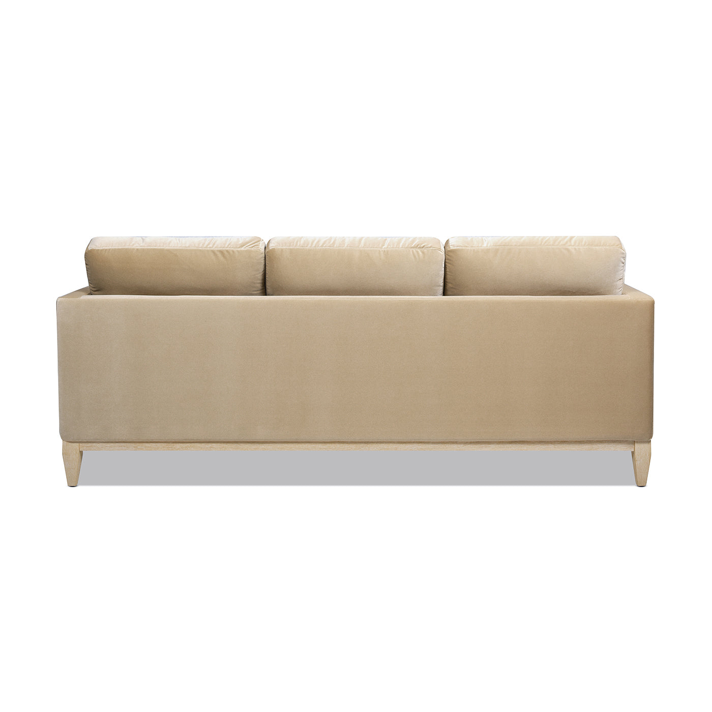 Beige velvet sofa with three plush cushions and light wood legs