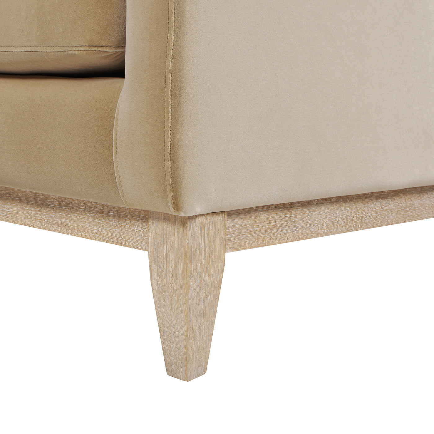 Beige velvet sofa detail with light wood tapered legs